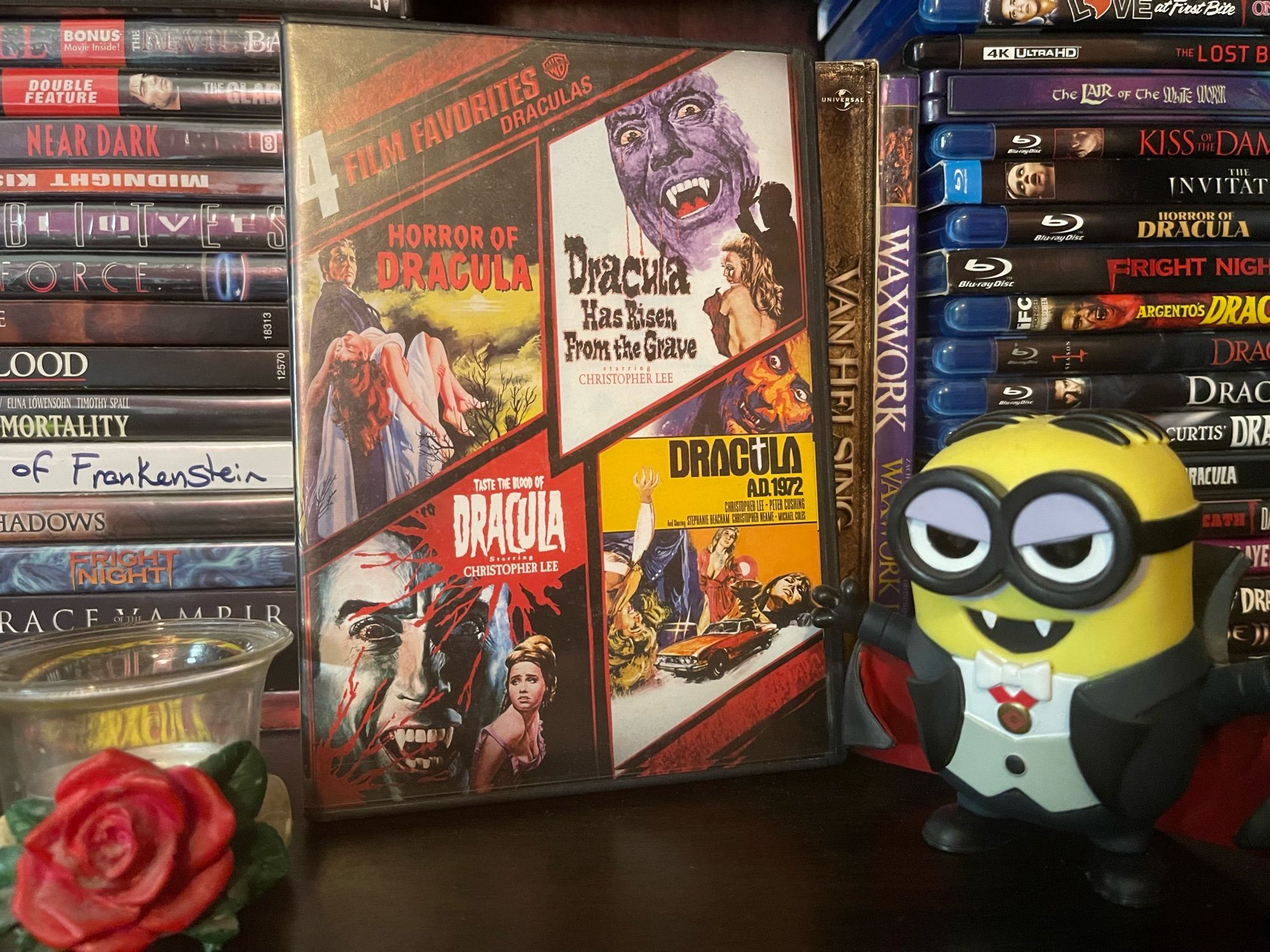 dracula movie on a dvd shelf with a minion funko pop dressed as dracula