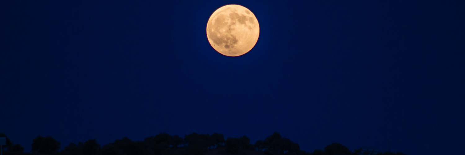 full moon over blue sky